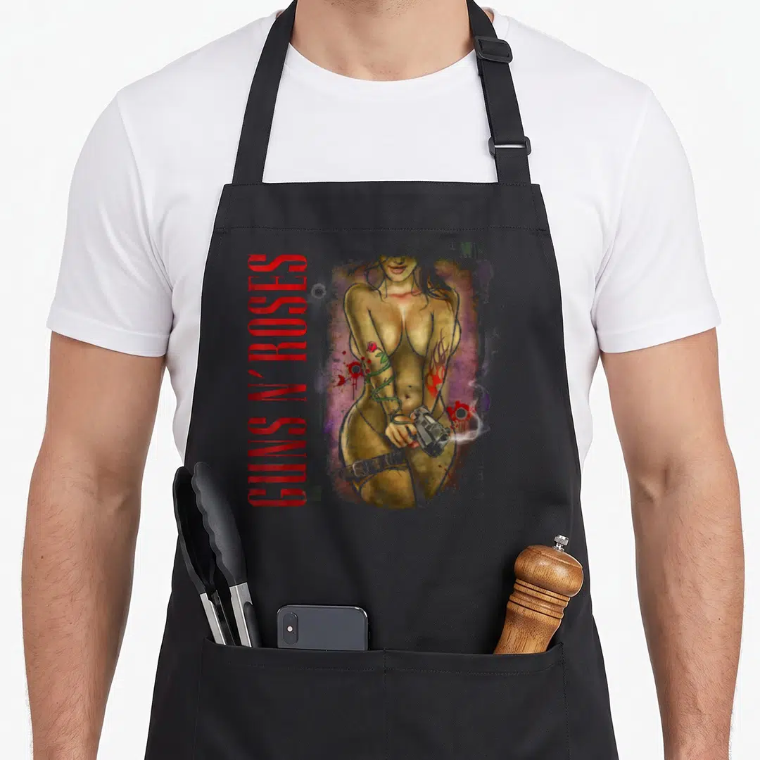 Gunslinger gun apron - Vertical GUNS N' ROSES text beside a gold woman holding a gun with tattoos and purple background — shown on a black cotton canvas apron against a white background