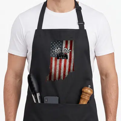 Indiana distressed apron - Indiana state map silhouette filled with red white blue flag and black race car with two — shown on a black cotton canvas apron against a white background