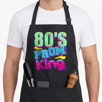 80s king apron - Stacked 80'S PROM King text in blue pink yellow purple with two lightning bolts — shown on a black cotton canvas apron against a white background