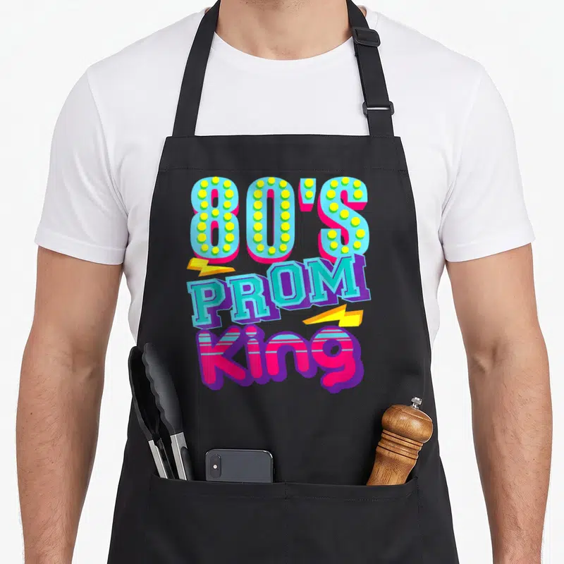 80s king apron - Stacked 80'S PROM King text in blue pink yellow purple with two lightning bolts — shown on a black cotton canvas apron against a white background