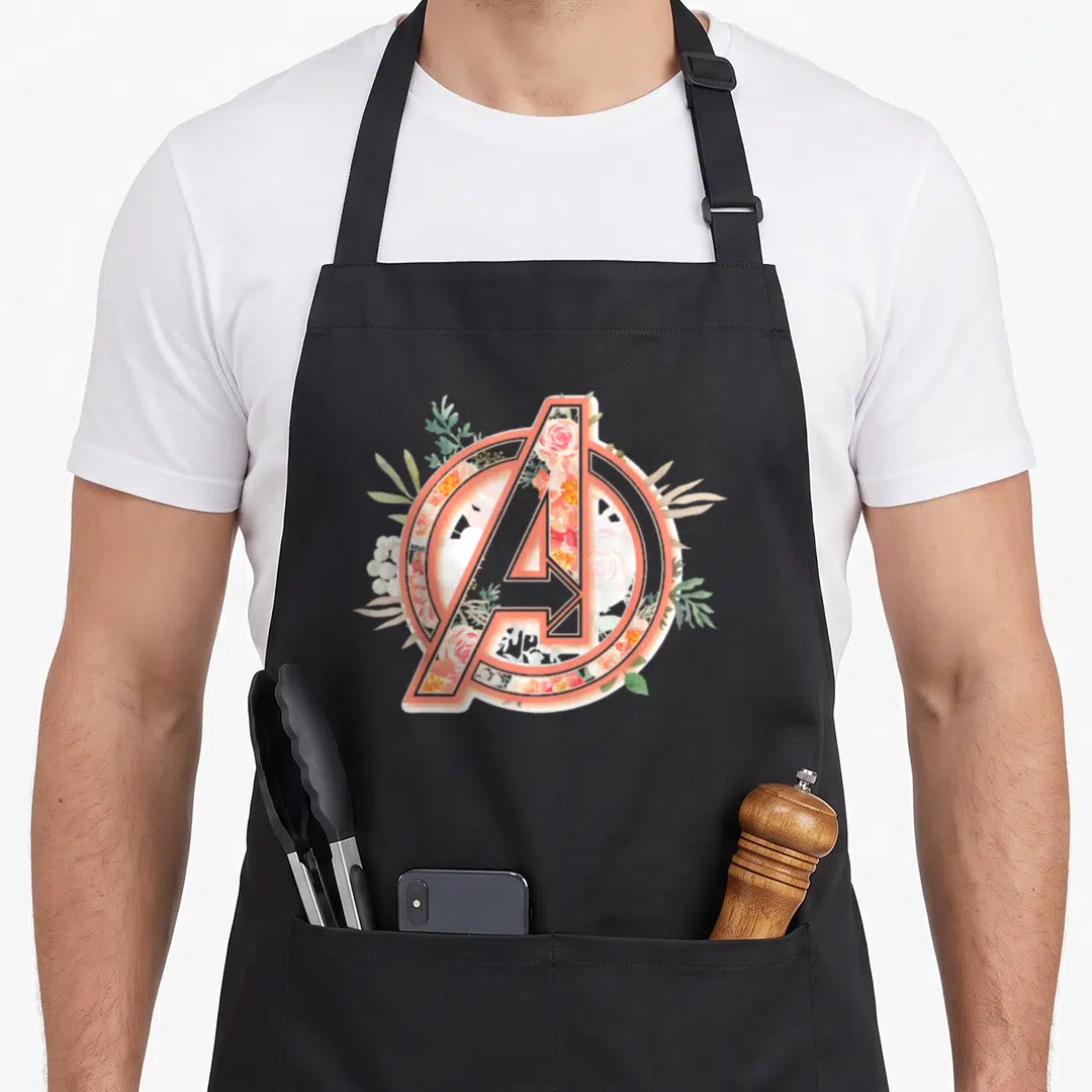 Funny fill floral apron - Peach-outlined letter A filled with roses and leaves in white and green, minimalist floral art — shown on a black cotton canvas apron against a white background