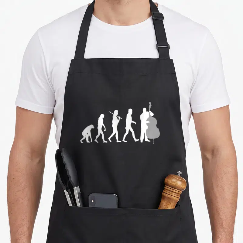 Evolution double apron - Five white silhouettes showing evolution of man ending with a double bass player — shown on a black cotton canvas apron against a white background