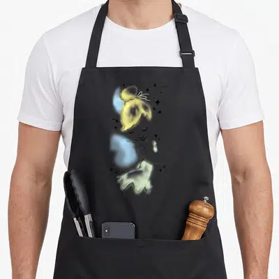 Peter novelty apron - Line art sketch of a girl with yellow hair and scattered small stars on a grey background — shown on a black cotton canvas apron against a white background