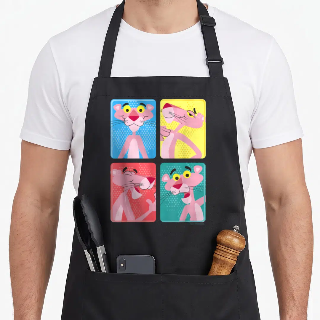 Portrait colorful apron - Four square panels of Pink Panther poses on blue, yellow, red, and teal halftone backgrounds — shown on a black cotton canvas apron against a white background