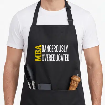 Dangerously master apron - Yellow and white text reading MBA vertically beside DANGEROUSLY OVEREDUCATED — shown on a black cotton canvas apron against a white background