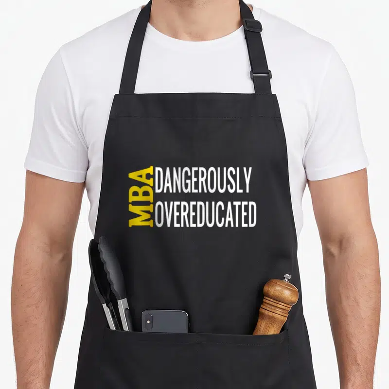 Dangerously master apron - Yellow and white text reading MBA vertically beside DANGEROUSLY OVEREDUCATED — shown on a black cotton canvas apron against a white background