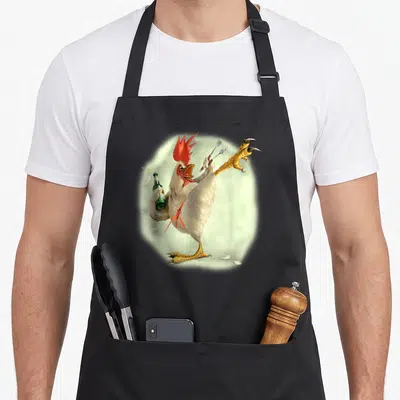 Beer chicken apron - Cartoon white rooster kicking with green bottle and two forks — shown on a black cotton canvas apron against a white background
