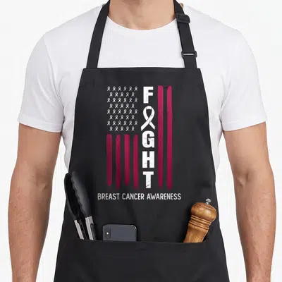 Flag month breast cancer awareness aprons - Distressed flag with vertical FIGHT, magenta stripes, white ribbons — shown on a black cotton canvas apron against a white background