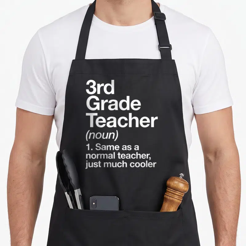 3rd art teacher apron - White text reading 3rd Grade Teacher noun same as normal teacher just cooler on black fabric — shown on a black cotton canvas apron against a white background