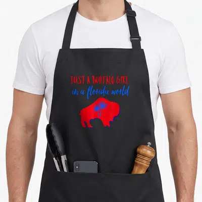 Buffalo florida apron - Red buffalo silhouette with blue palm trees and stacked red and blue text — shown on a black cotton canvas apron against a white background