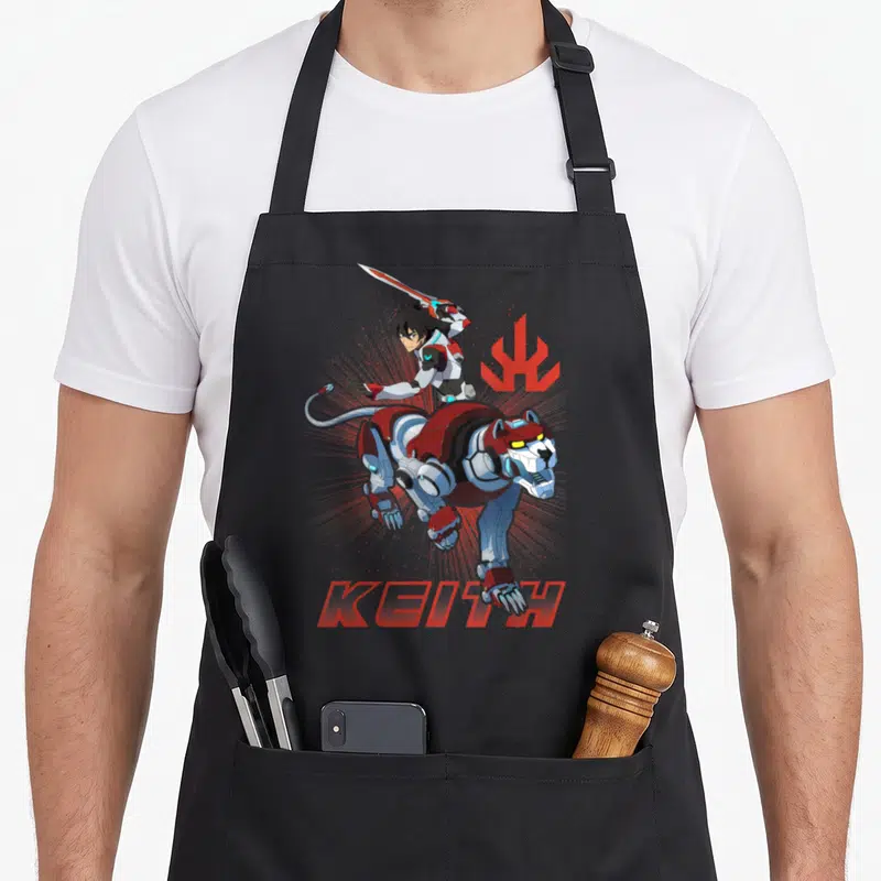 Paladin defender apron - Cartoon robotic panther with sword pilot and KEITH text in red white grey — shown on a black cotton canvas apron against a white background