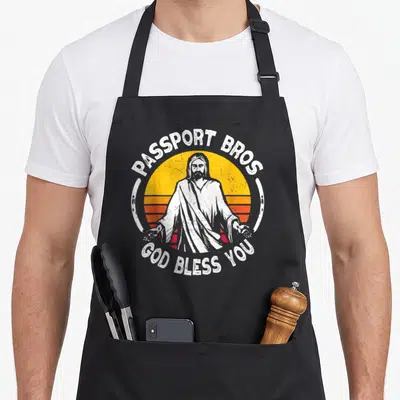 Passport meme apron - Jesus figure with Passport Bros text over striped retro sun in distressed white yellow orange red — shown on a black cotton canvas apron against a white background
