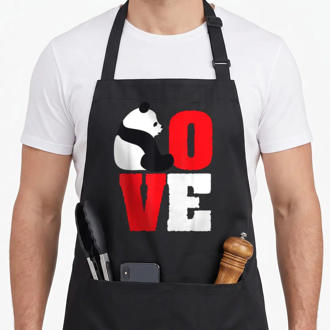 Vintage panda bear apron - Panda shaped like L beside red O and white E spelling LOVE in minimalist style — shown on a black cotton canvas apron against a white background