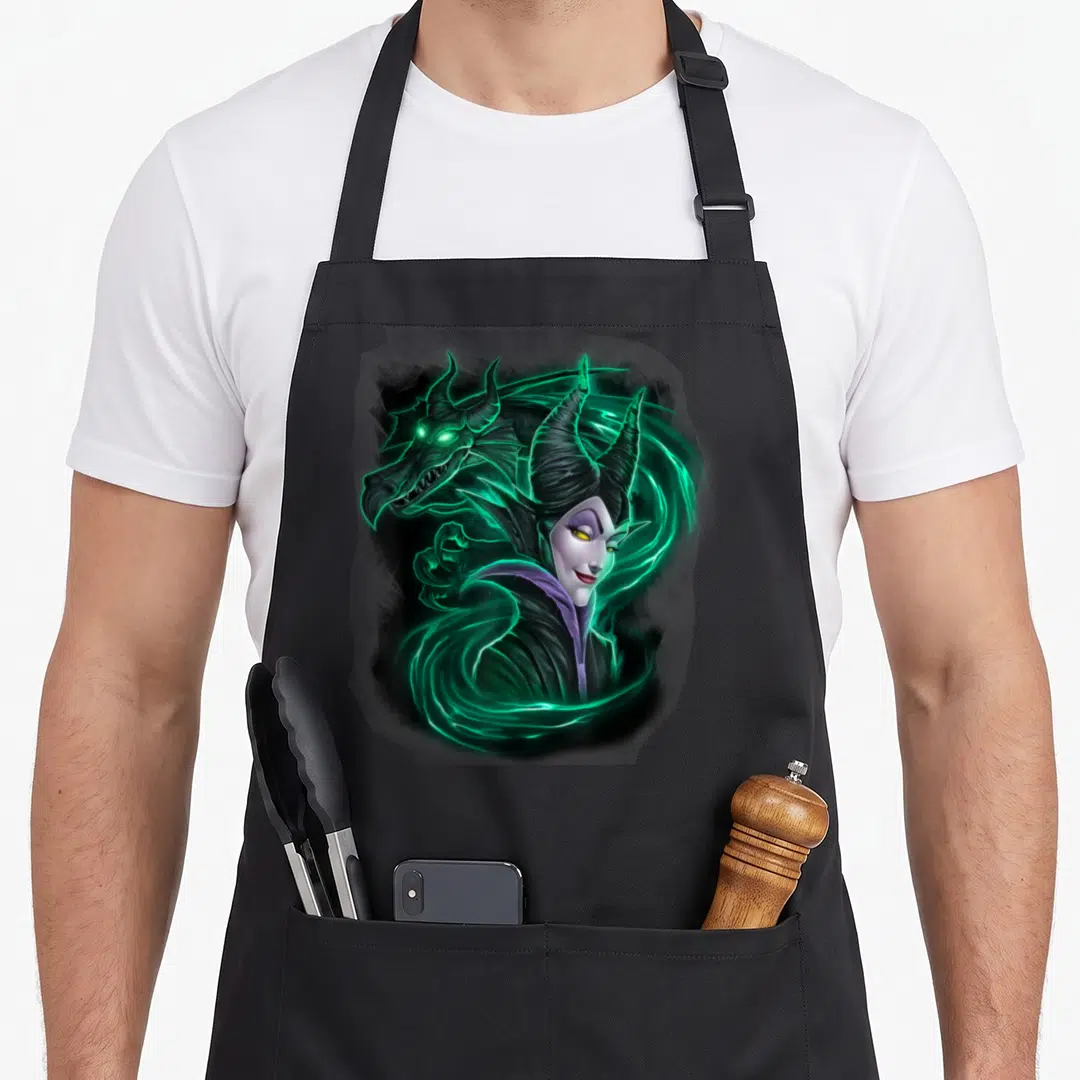 Magic beauty apron - Realistic Maleficent portrait with dragon head and glowing green energy swirls — shown on a black cotton canvas apron against a white background