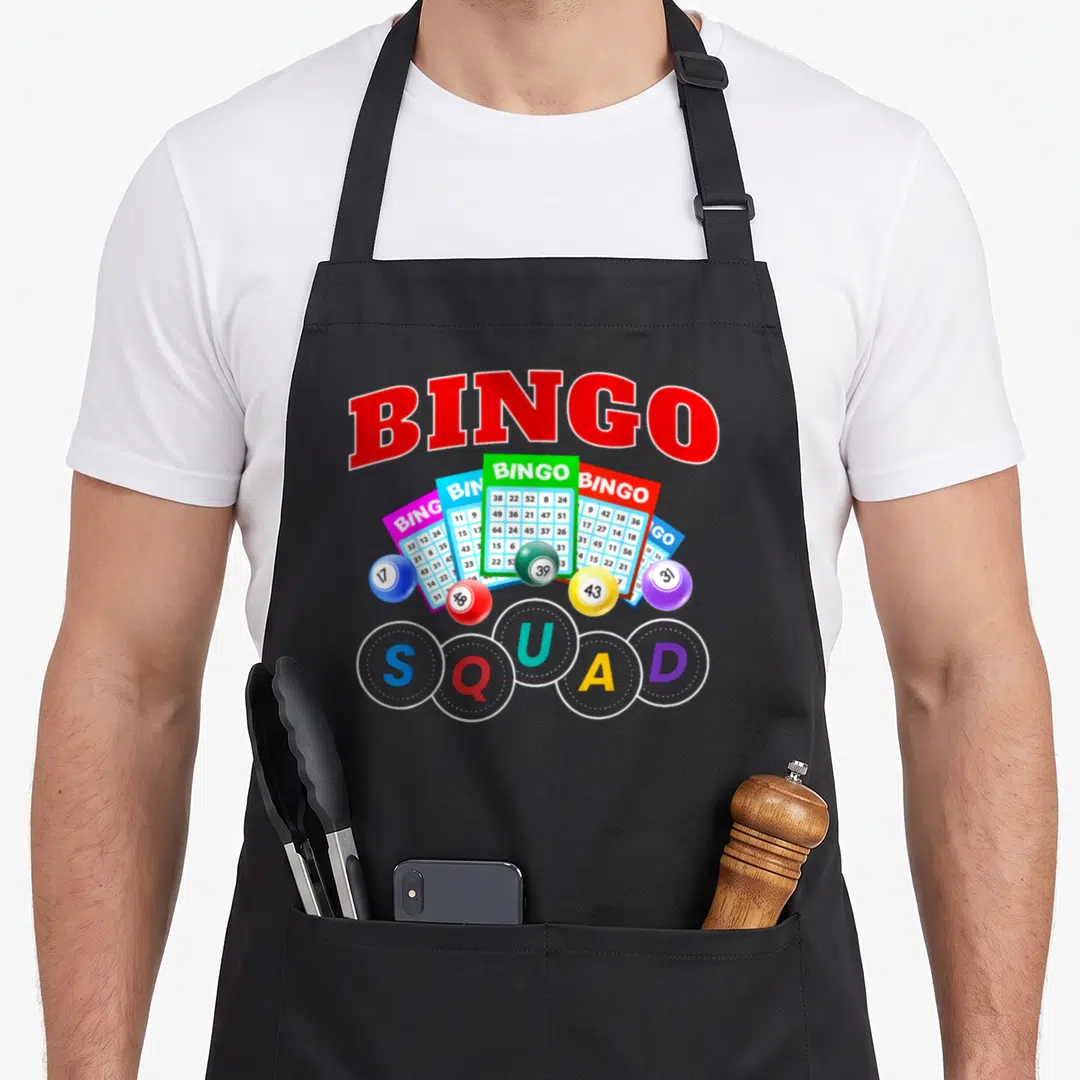 Squad bingo aprons - Five bingos text, fanned cards, colored balls, squad circles — shown on a black cotton canvas apron against a white background