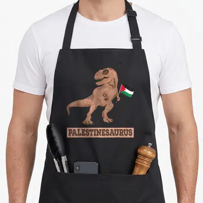Rex palestinian apron - Brown dinosaur holding red black white and green flag with PALESTINESAURUS text below — shown on a black cotton canvas apron against a white background