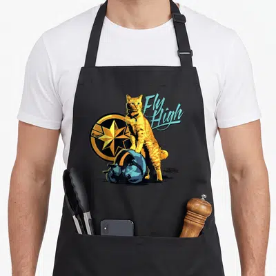 Symbol goose apron - Orange cat standing near blue helmet and star emblem with Fly High text — shown on a black cotton canvas apron against a white background