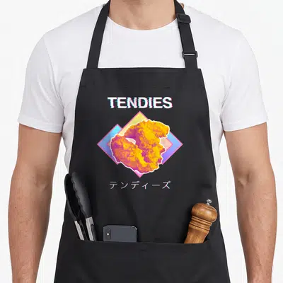Vaporwave chicken apron - Retro TENDIES text above fried chicken tender over diamond shape with Japanese katakana below — shown on a black cotton canvas apron against a white background