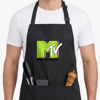 Mtv lime green apron - 3D lime green M logo with white TV script and MUSIC TELEVISION text in purple and black — shown on a black cotton canvas apron against a white background