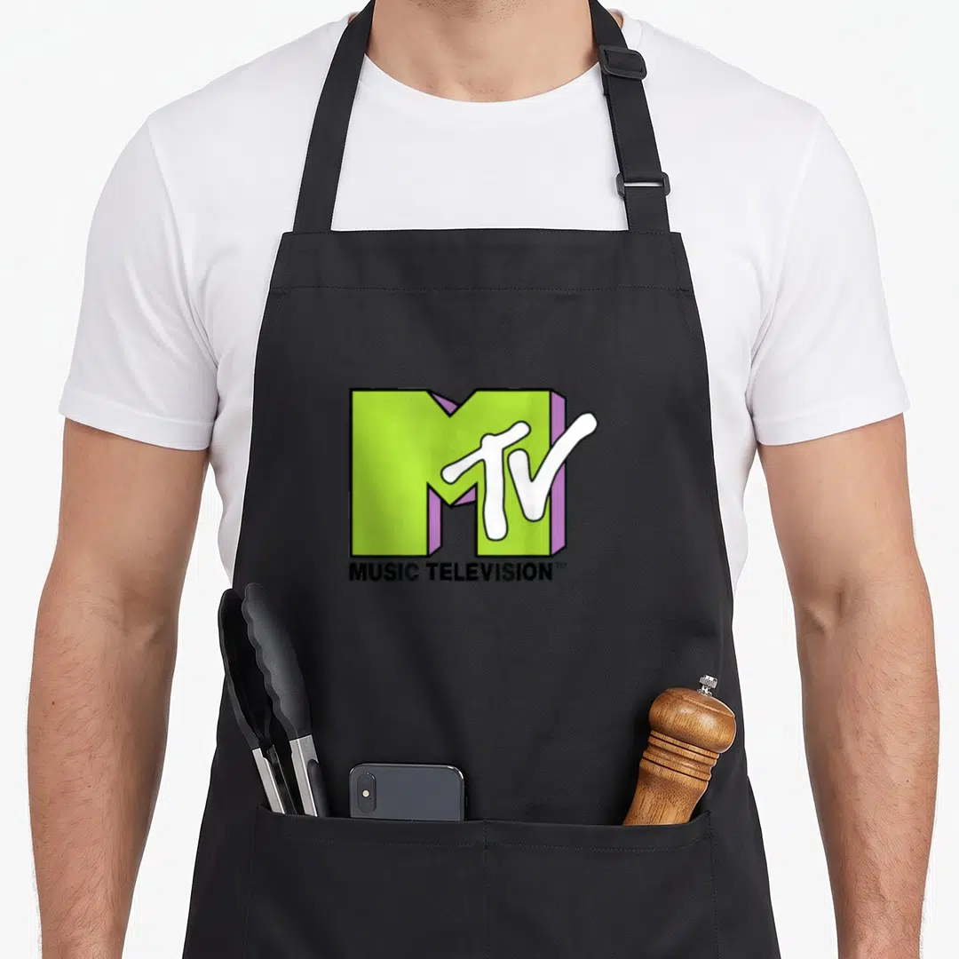 Mtv lime green apron - 3D lime green M logo with white TV script and MUSIC TELEVISION text in purple and black — shown on a black cotton canvas apron against a white background