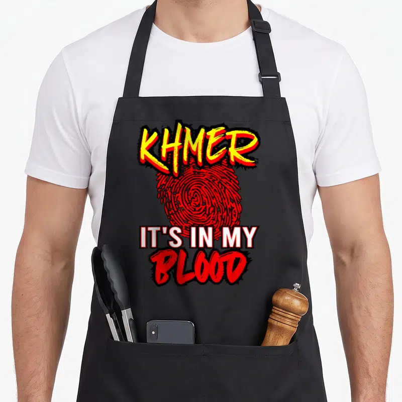 Khmer cambodia cambodian girl apron - Red fingerprint with KHMER IT'S IN MY BLOOD text in yellow and white — shown on a black cotton canvas apron against a white background