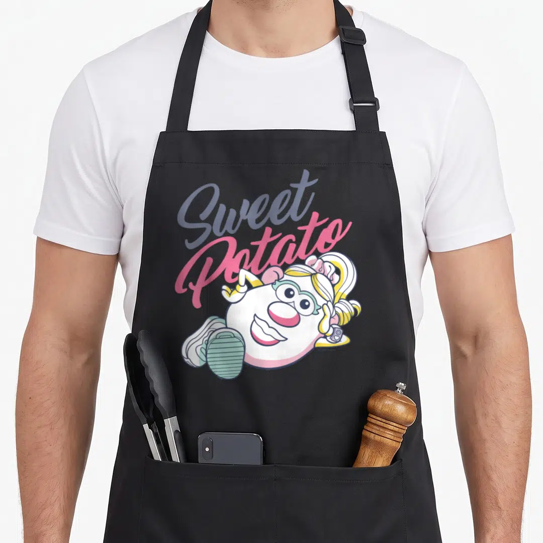 Valentine mr mrs aprons - Sweet Potato text above white cartoon character with pink and blue-grey accents — shown on a black cotton canvas apron against a white background