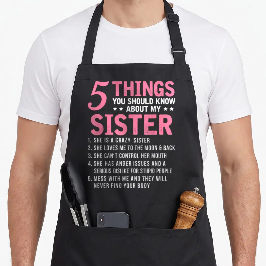 Should sister novelty apron - Pink and white 5 Things You Should Know About My Sister text with stars and numbered list — shown on a black cotton canvas apron against a white background