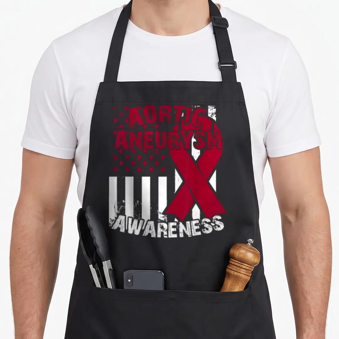 Awareness aortic ribbon apron - Distressed red and white Aortic Aneurysm Awareness text with ribbon and stars — shown on a black cotton canvas apron against a white background