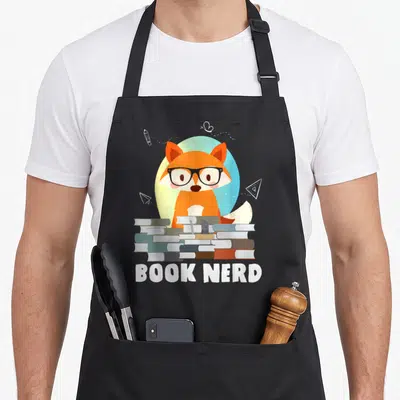 Bookworm crazy mouse man apron - Orange fox with glasses behind stacked books and BOOK NERD text — shown on a black cotton canvas apron against a white background