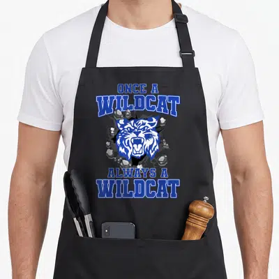 Alway wildcat school apron - Blue white wildcat head bursting cracked wall flying rocks once always wildcat text — shown on a black cotton canvas apron against a white background