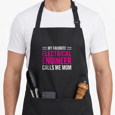 Electrical mother's apron - Pink and white text MY FAVORITE ELECTRICAL ENGINEER CALLS ME MOM with horizontal lines — shown on a black cotton canvas apron against a white background