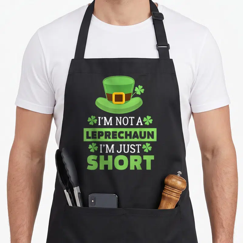 Vintage leprechaun st patrick day aprons - Green leprechaun hat above stacked white and grey text reading I'M NOT — shown on a black cotton canvas apron against a white background