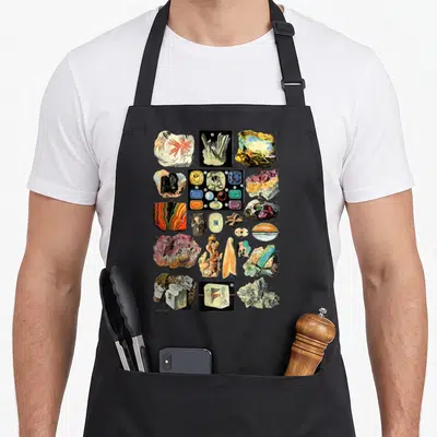 Mineral collecting apron - Grid of realistic mineral specimens, crystals, and a small statue in white blue yellow red — shown on a black cotton canvas apron against a white background