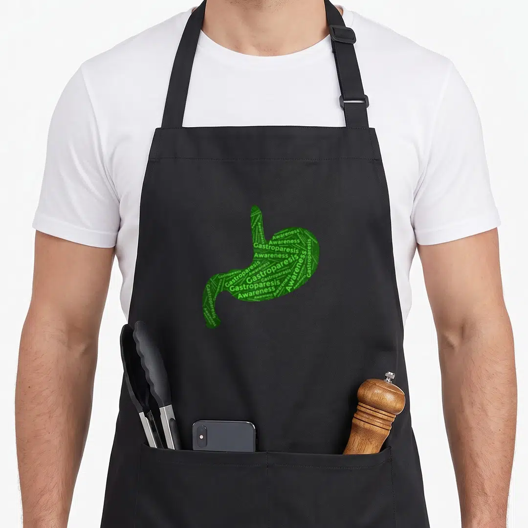 Gastrointestinal gastroparesis awareness apron - Stomach shape formed by repeated Gastroparesis Awareness text in green — shown on a black cotton canvas apron against a white background