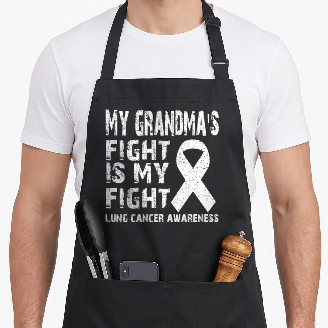 Fight grandma's aprons - Distressed white text My Grandma's Fight Is My Fight beside a white ribbon — shown on a black cotton canvas apron against a white background