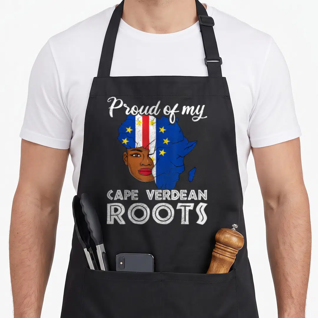 Proud cape verde apron - Proud of my Cape Verdean Roots text around a woman's face and flag-patterned Africa map — shown on a black cotton canvas apron against a white background