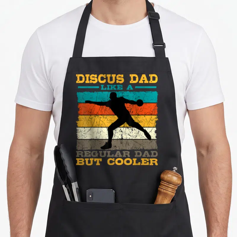 Discus father day apron - Black discus thrower silhouette over yellow blue orange grey stripes with retro text — shown on a black cotton canvas apron against a white background