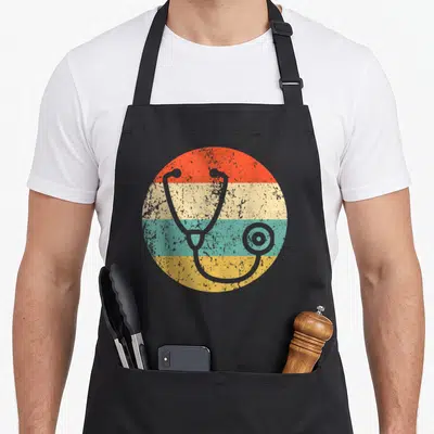 Nurse doctor apron - Grey stethoscope over four horizontal stripes in orange beige teal and yellow — shown on a black cotton canvas apron against a white background