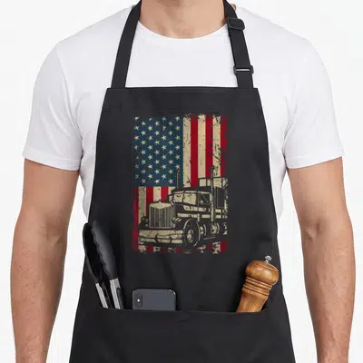 Driver flag truck apron - Distressed American flag with superimposed semi-truck silhouette in red white blue beige — shown on a black cotton canvas apron against a white background