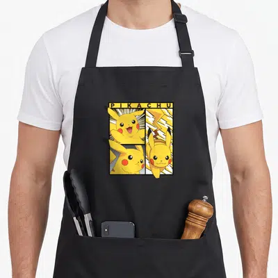 Trend apron with pockets - Pikachu in three comic poses with lightning bolt and yellow title bar inside black frame — shown on a black cotton canvas apron against a white background