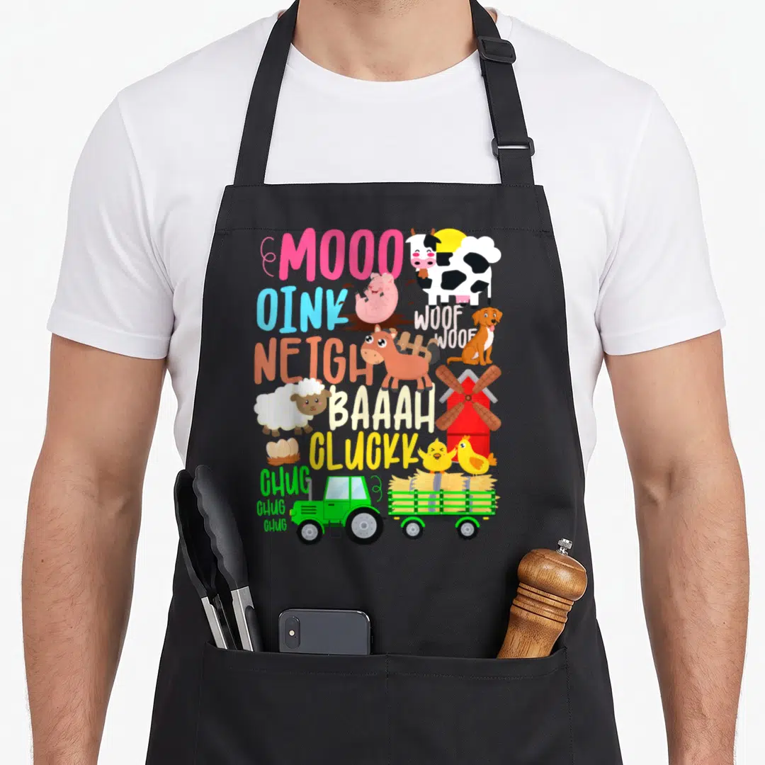 Neigh farm apron - Cartoon cow pig horse sheep dog chicken tractor windmill with sound words MOOO OINK NEIGH — shown on a black cotton canvas apron against a white background