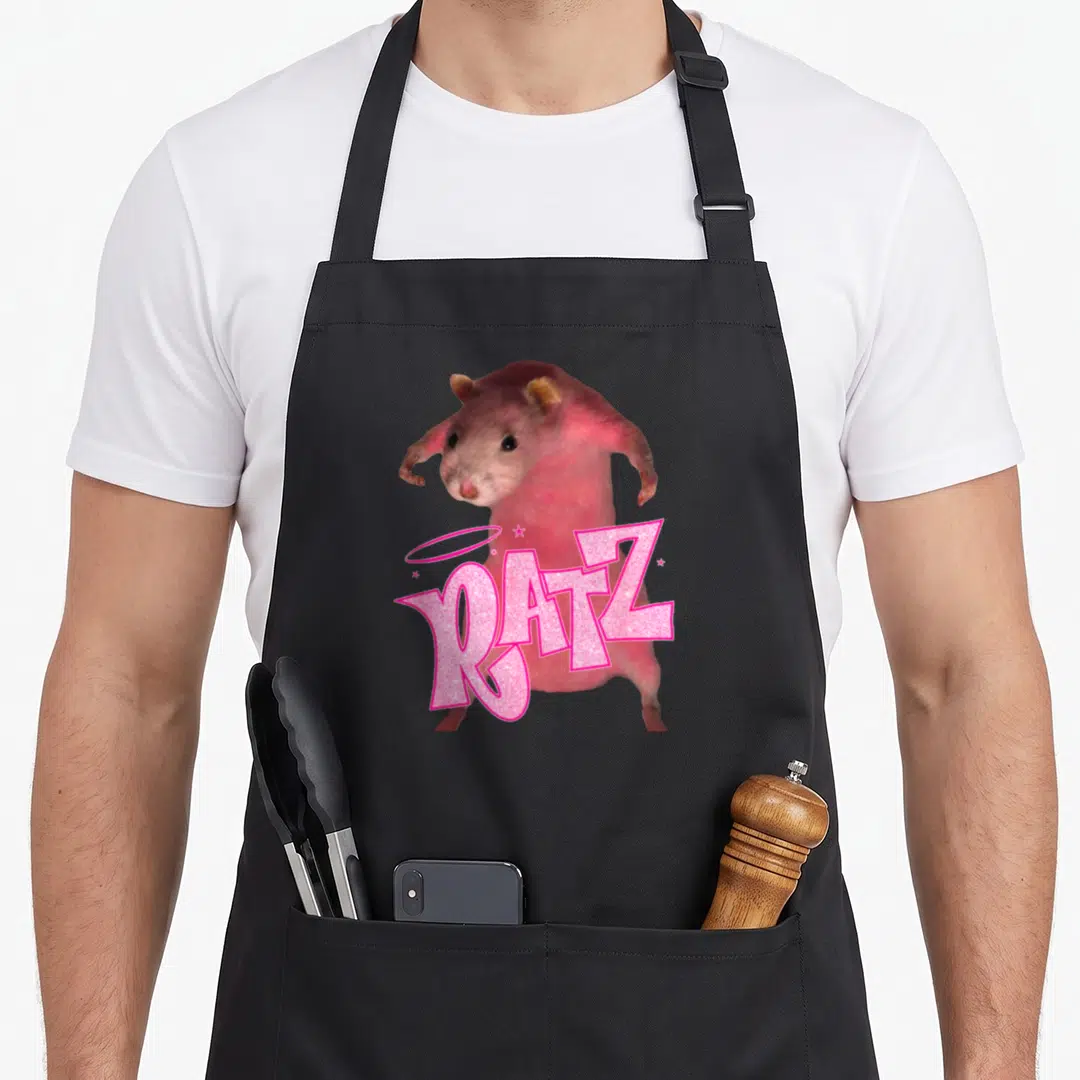 Ratz rat dad apron - Pink rat behind glittery RATZ text with halo and two stars — shown on a black cotton canvas apron against a white background