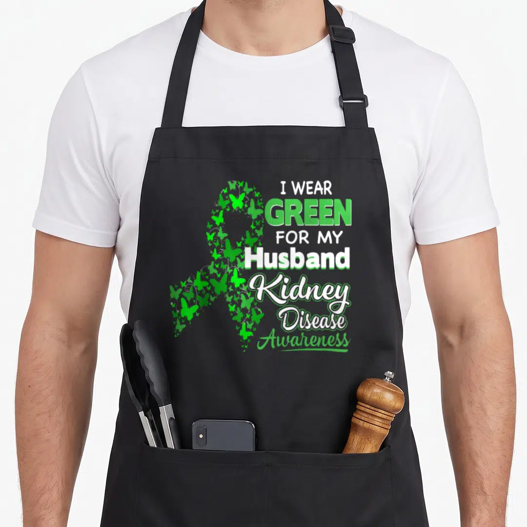 Kidney husband apron - Green butterfly ribbon and I Wear Green for my Husband Kidney Disease Awareness text — shown on a black cotton canvas apron against a white background