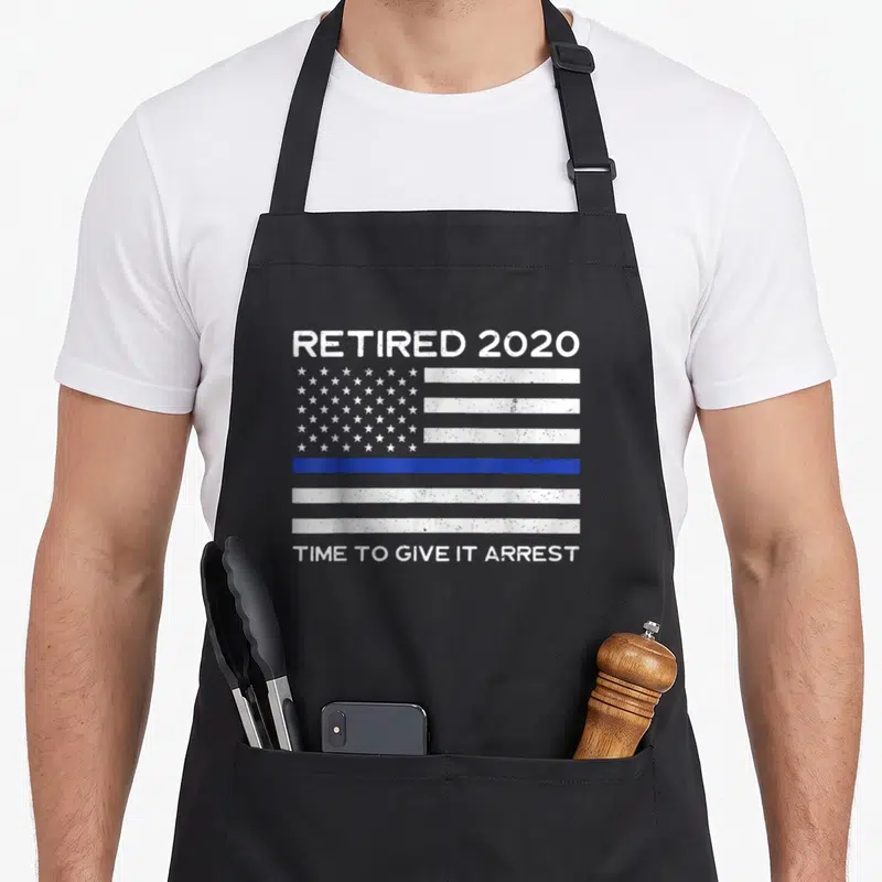 Enforcement police apron - Distressed flag with blue line and text Retired 2020 Time to Give It Arrest — shown on a black cotton canvas apron against a white background