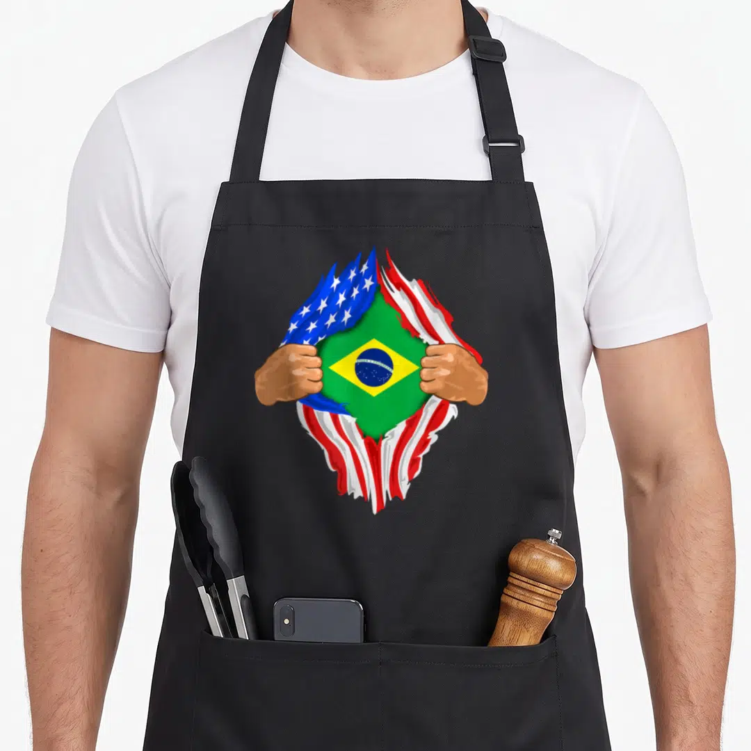 Brazilian blood apron - Two hands tearing USA flag revealing Brazilian flag with green yellow blue red white colors — shown on a black cotton canvas apron against a white background