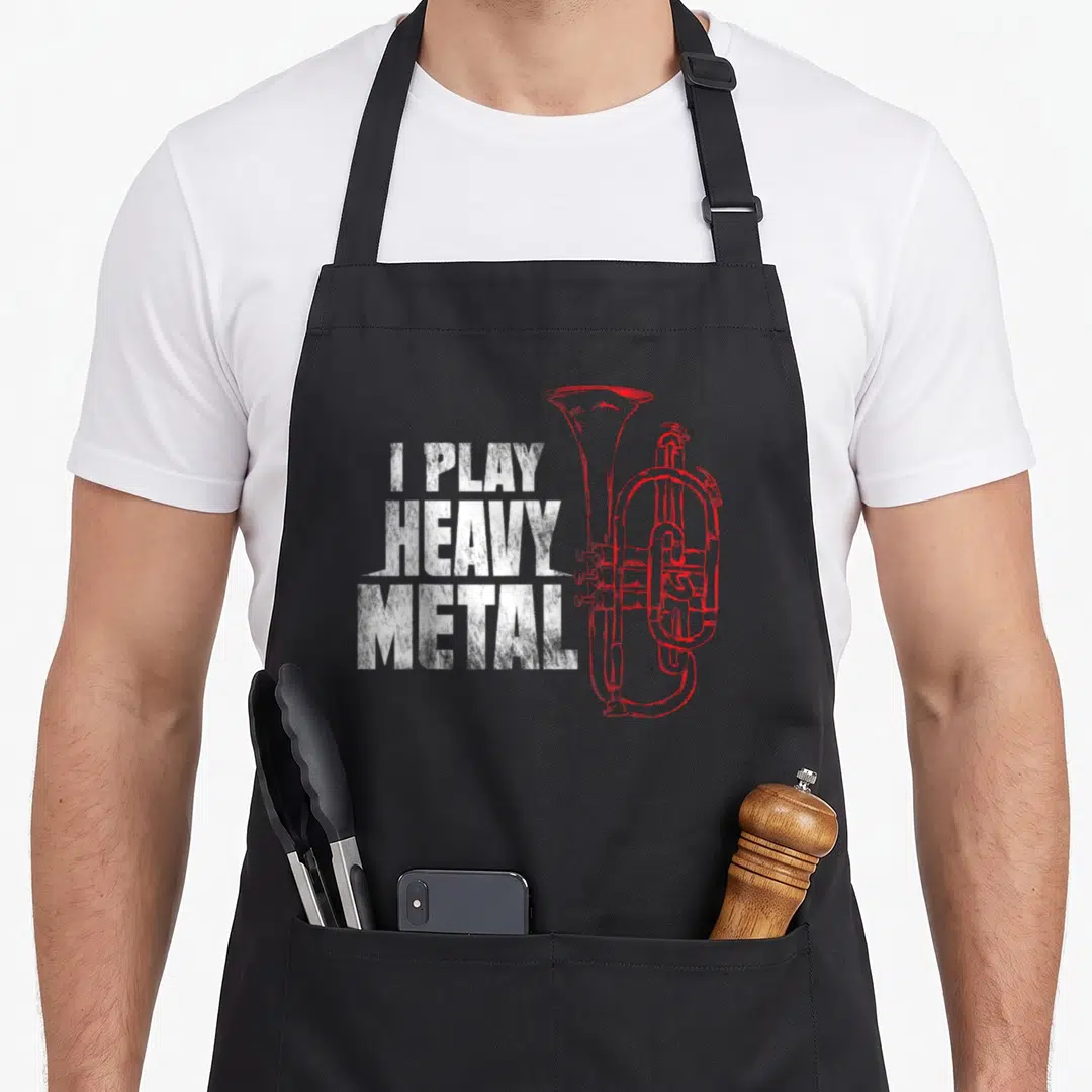 Baritone tuba apron - I Play Heavy Metal distressed text with red line-art tuba illustration — shown on a black cotton canvas apron against a white background