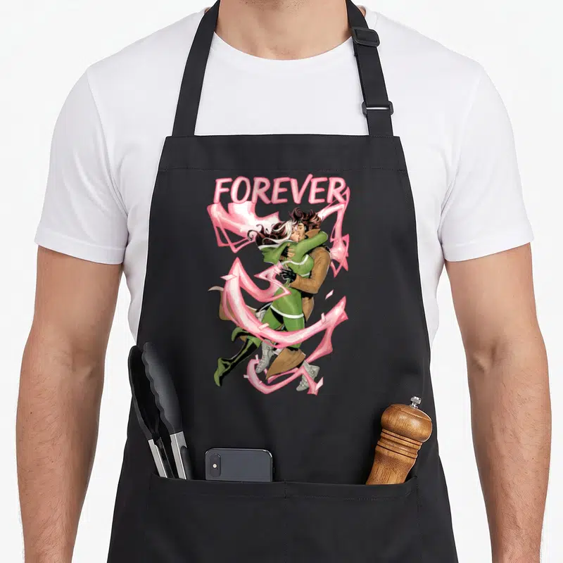 Rogue valentine's day apron - FOREVER text above cartoon couple kissing with pink energy ribbons in green and brown — shown on a black cotton canvas apron against a white background