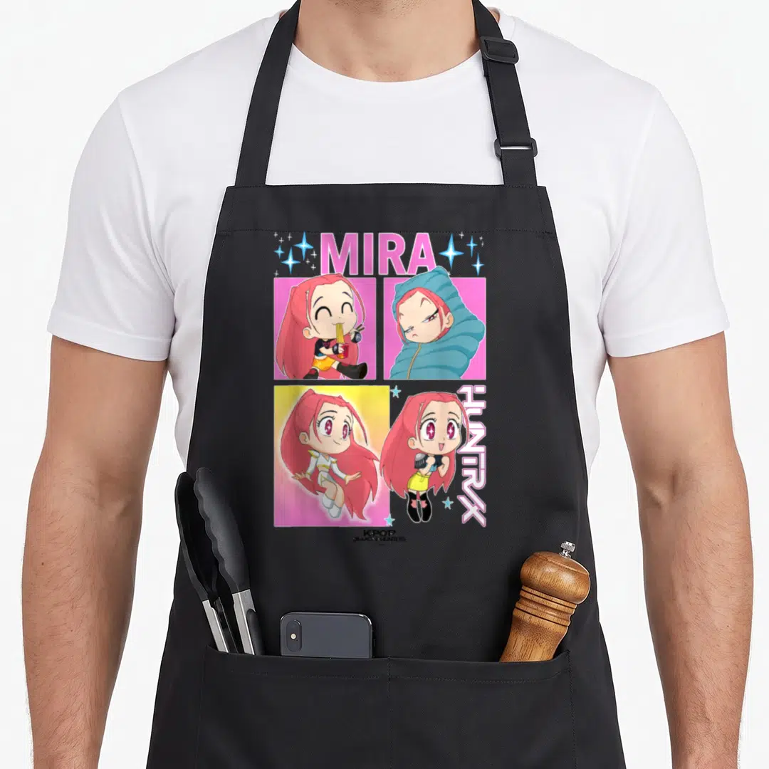 Mira trend apron - Cartoon girl portraits in pink blue and yellow with MIRA HUNTRX text — shown on a black cotton canvas apron against a white background