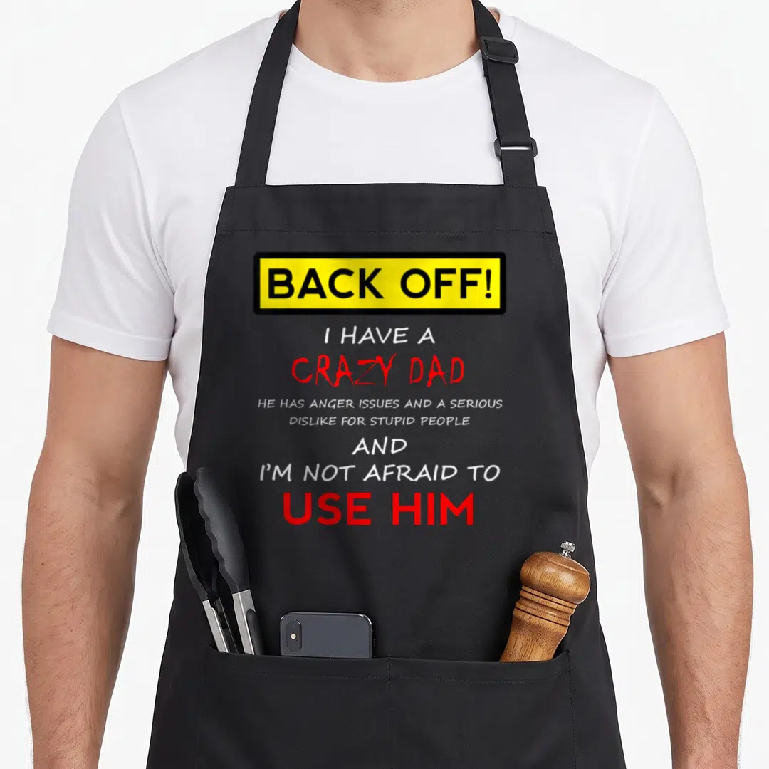 Funny daughter dad and son aprons - Yellow box reads back off red text says I have a crazy dad anger issues dislike — shown on a black cotton canvas apron against a white background