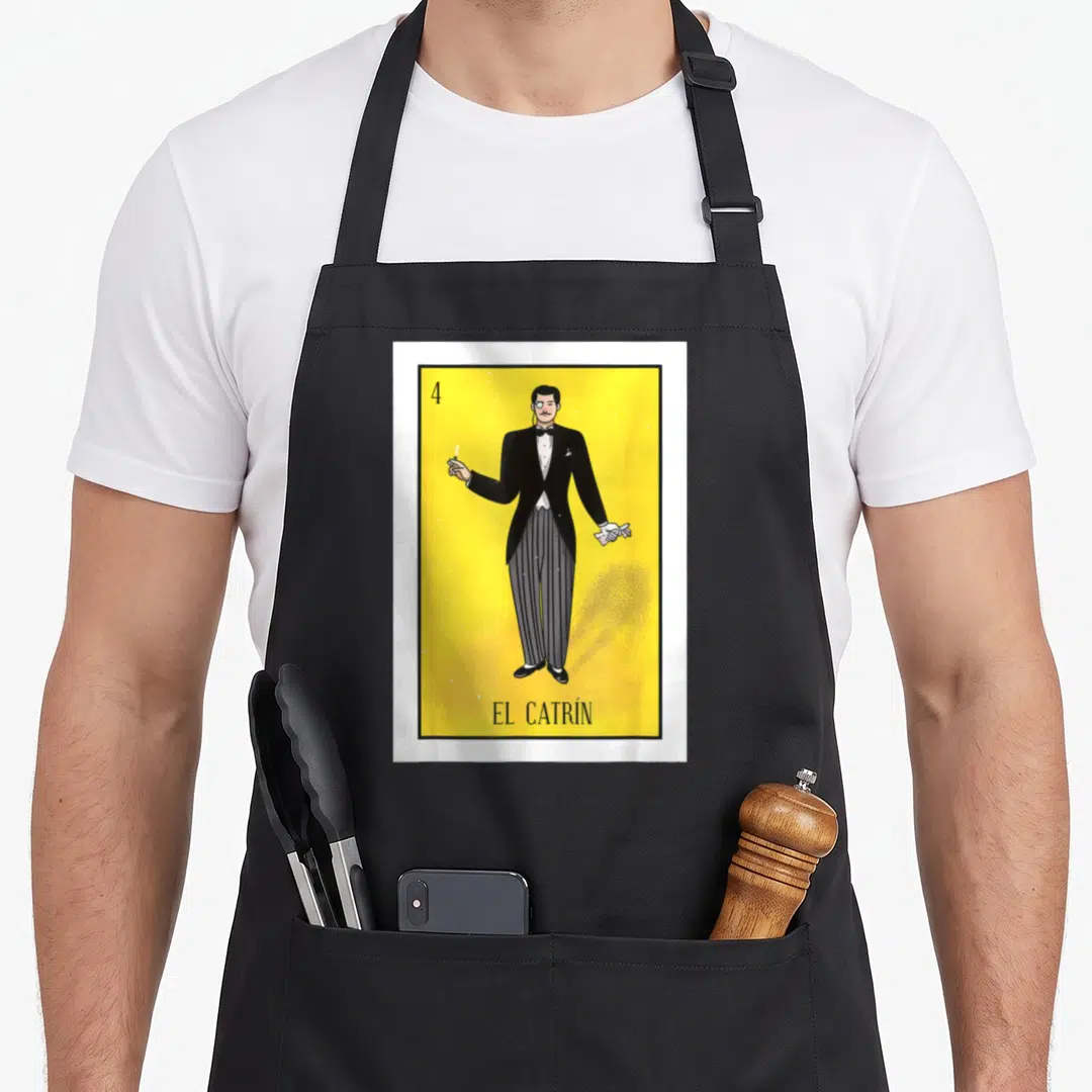 Catrin mexican apron - Man in tuxedo on yellow background with number 4 and EL CATRÍN text — shown on a black cotton canvas apron against a white background